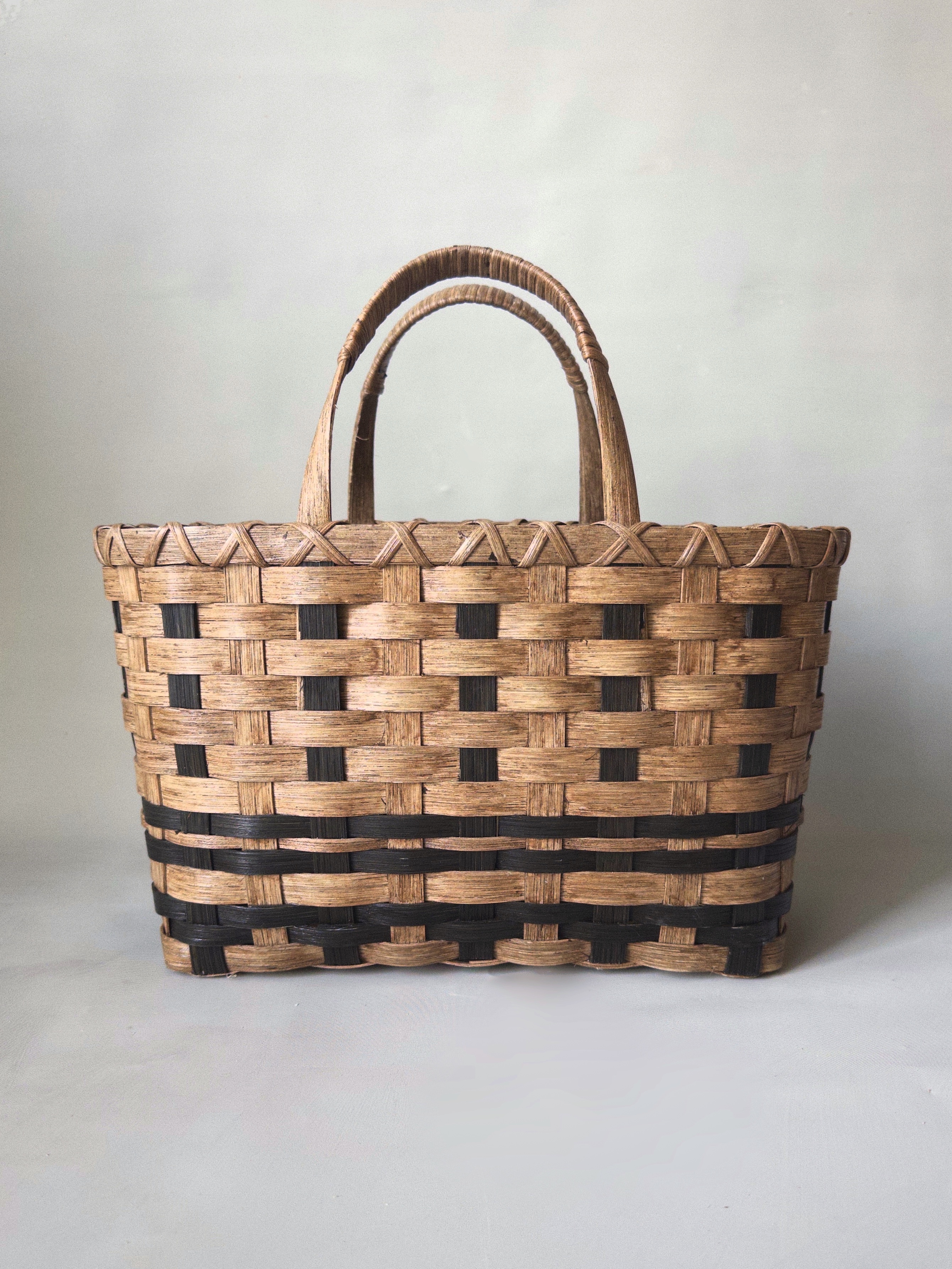 Heritage Striped Tote Basket with a striped weave and wrapped reed handles