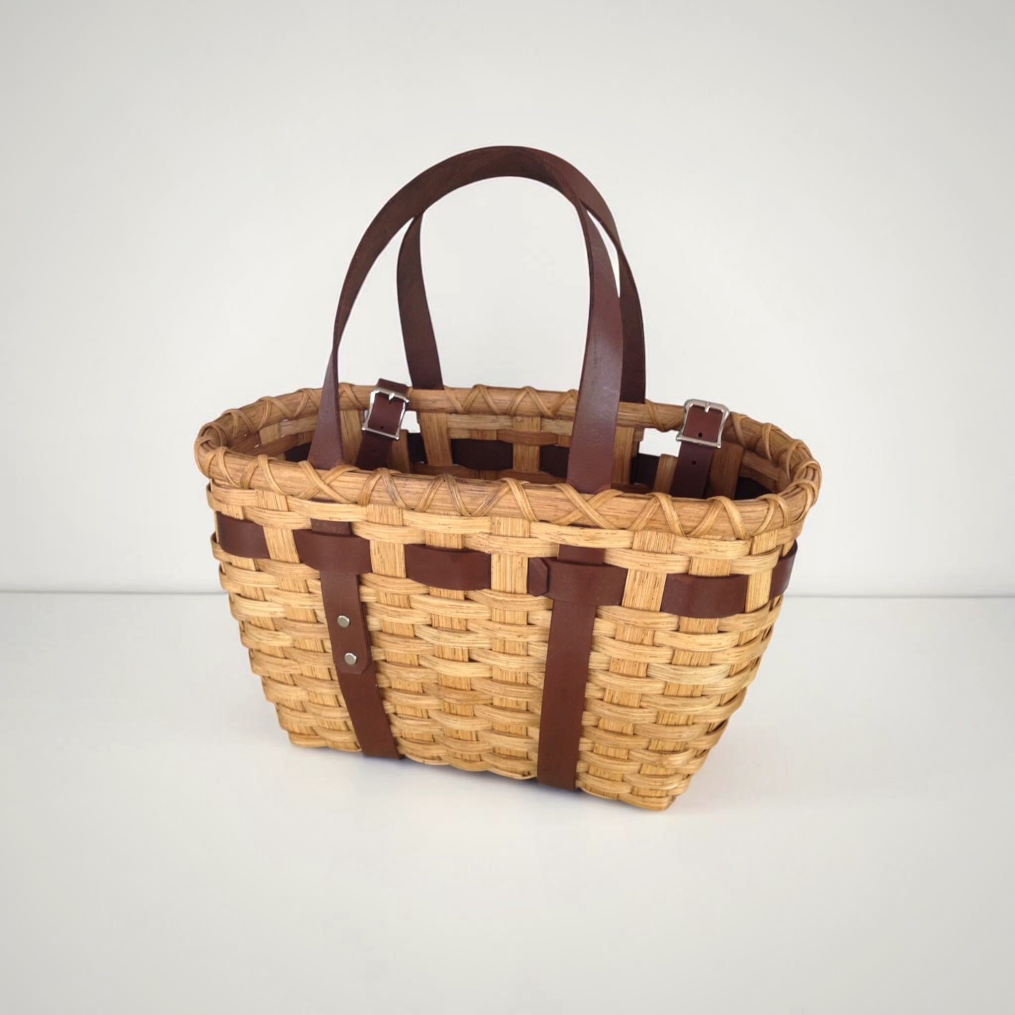 Bicycle Tote Basket buckled onto the handlebars of a bike